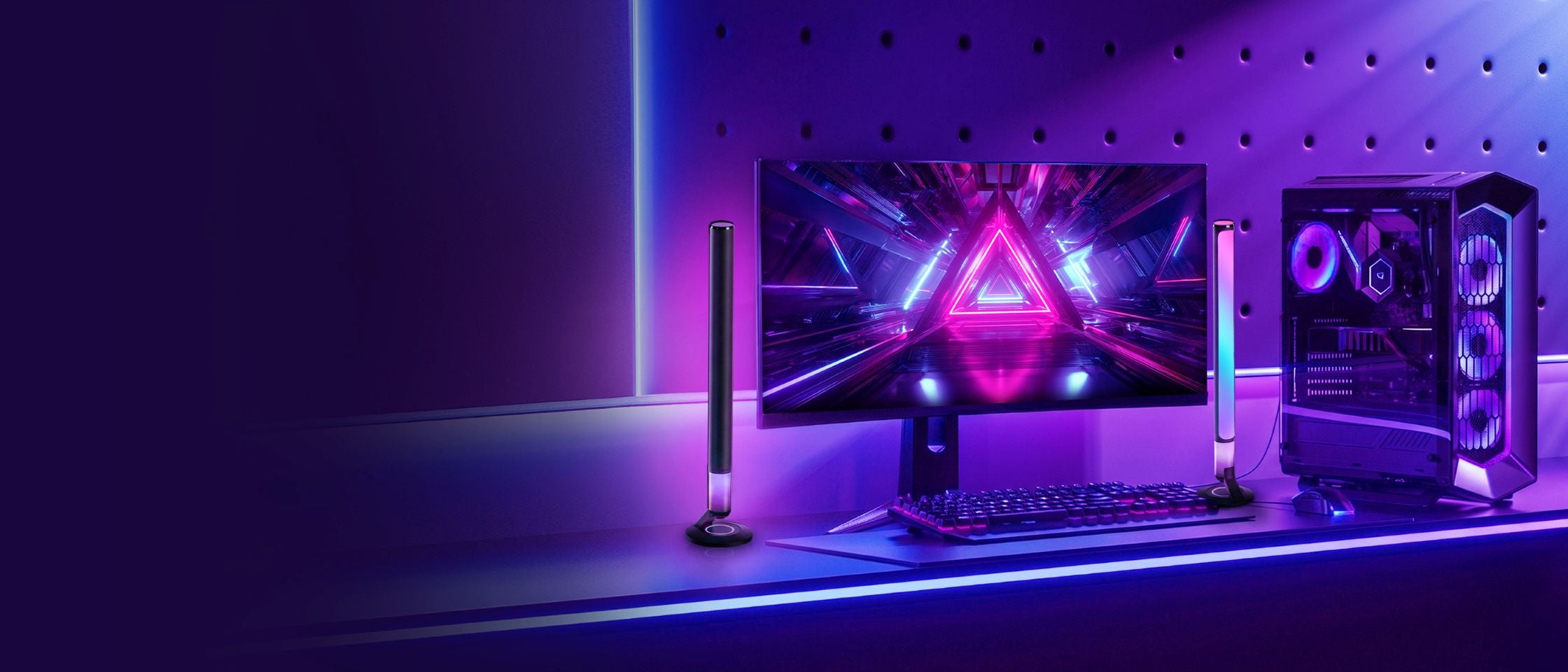 Gaming setup with monitor, keyboard, and RGB-lit components on a dark background